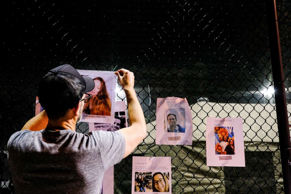 PHOTO: A man hangs up signs of missing residents from the partial collapse in Surfside where the rescue personnel continue their search for victims the day after in Surfside near Miami Beach, Florida, U.S., June 25, 2021. REUTERS/Maria Alejandra Cardona