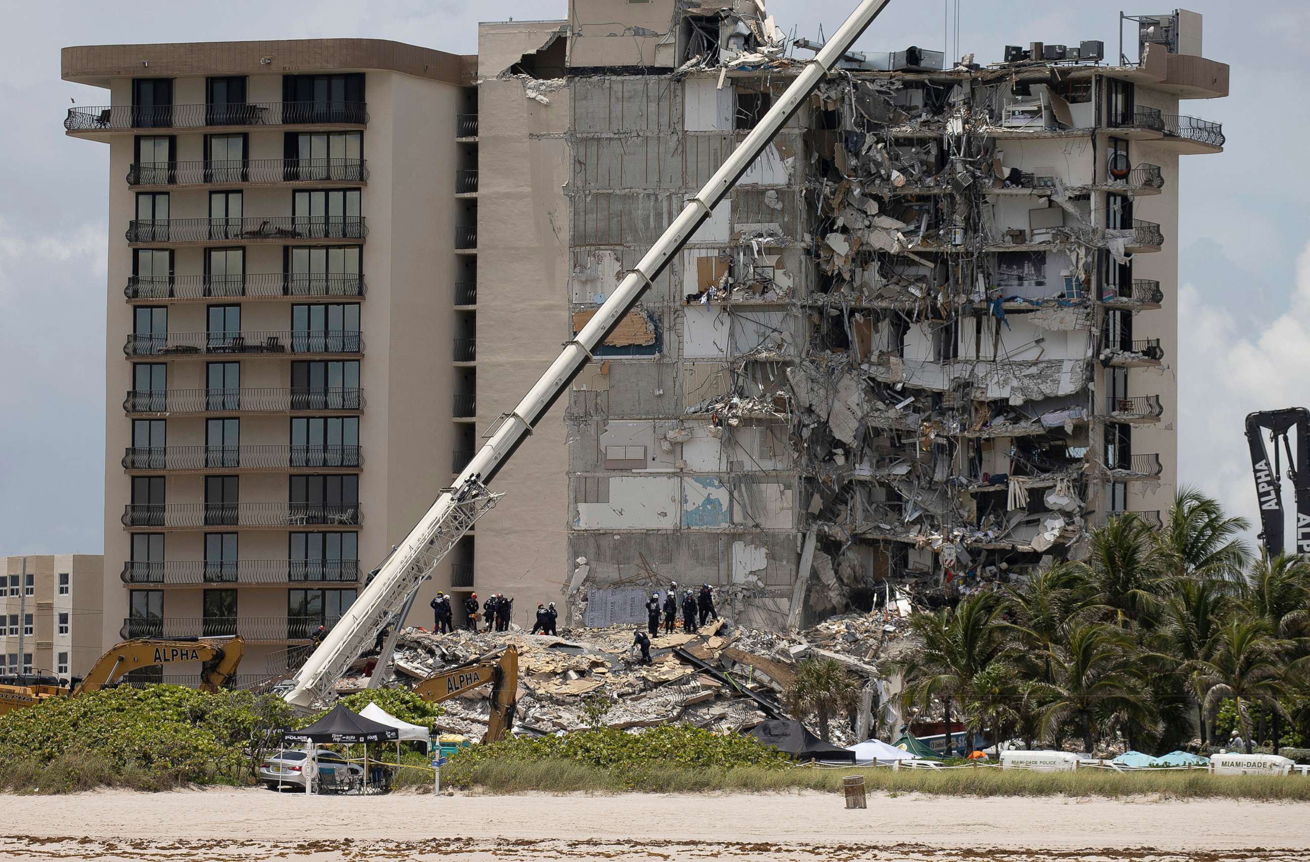 PHOTO: Members of the South Florida Urban Search and Rescue team look for possible survivors in the partially collapsed 12-story Champlain Towers South condo building, June 26, 2021, in Surfside, Florida.