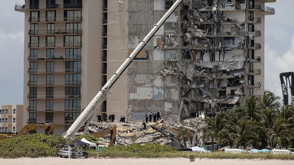 PHOTO: Members of the South Florida Urban Search and Rescue team look for possible survivors in the partially collapsed 12-story Champlain Towers South condo building, June 26, 2021, in Surfside, Florida.