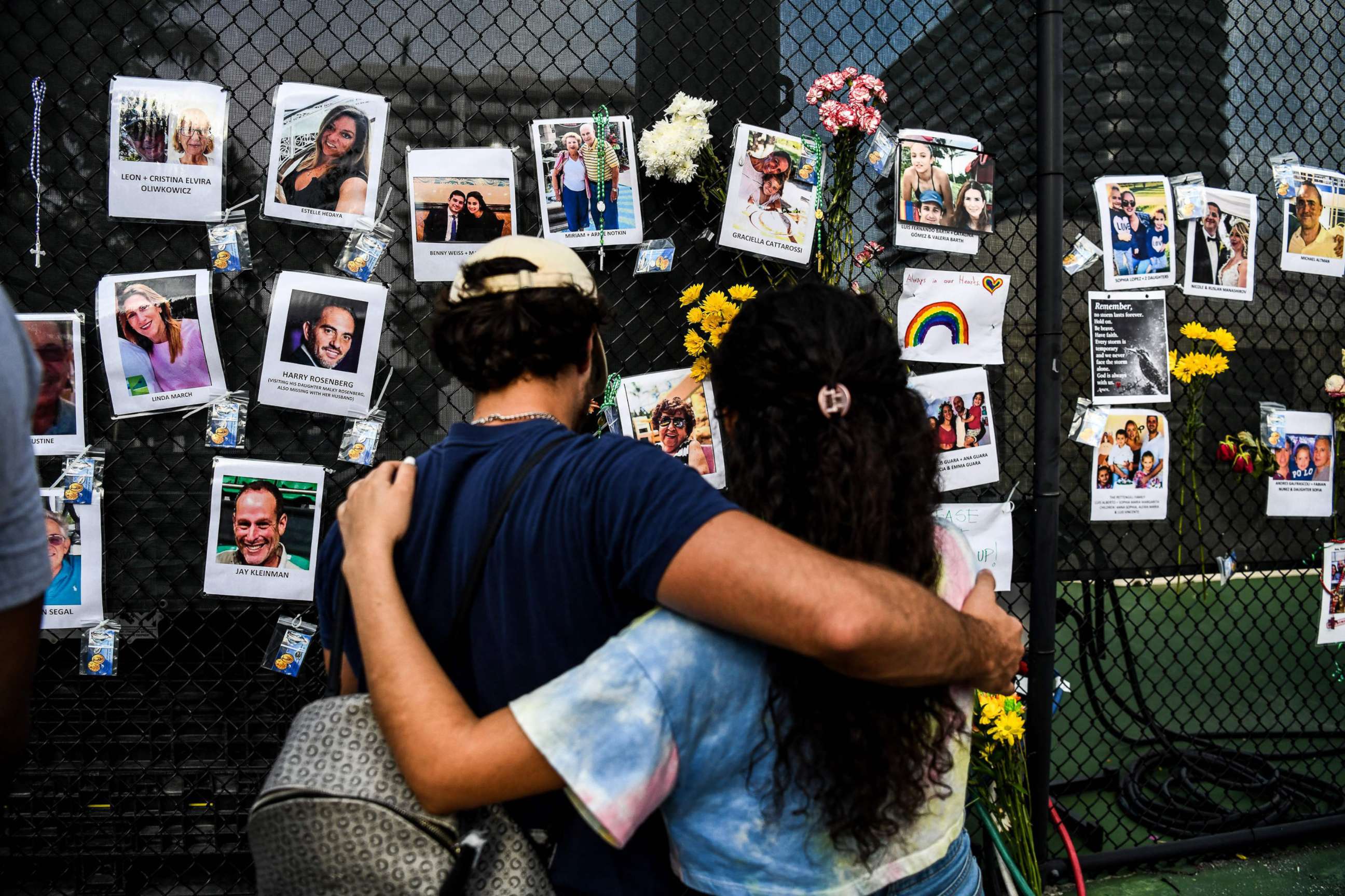 PHOTO: People visit the makeshift memorial for the victims of the building collapse, near the site of the accident in Surfside, Fla., June 27, 2021.