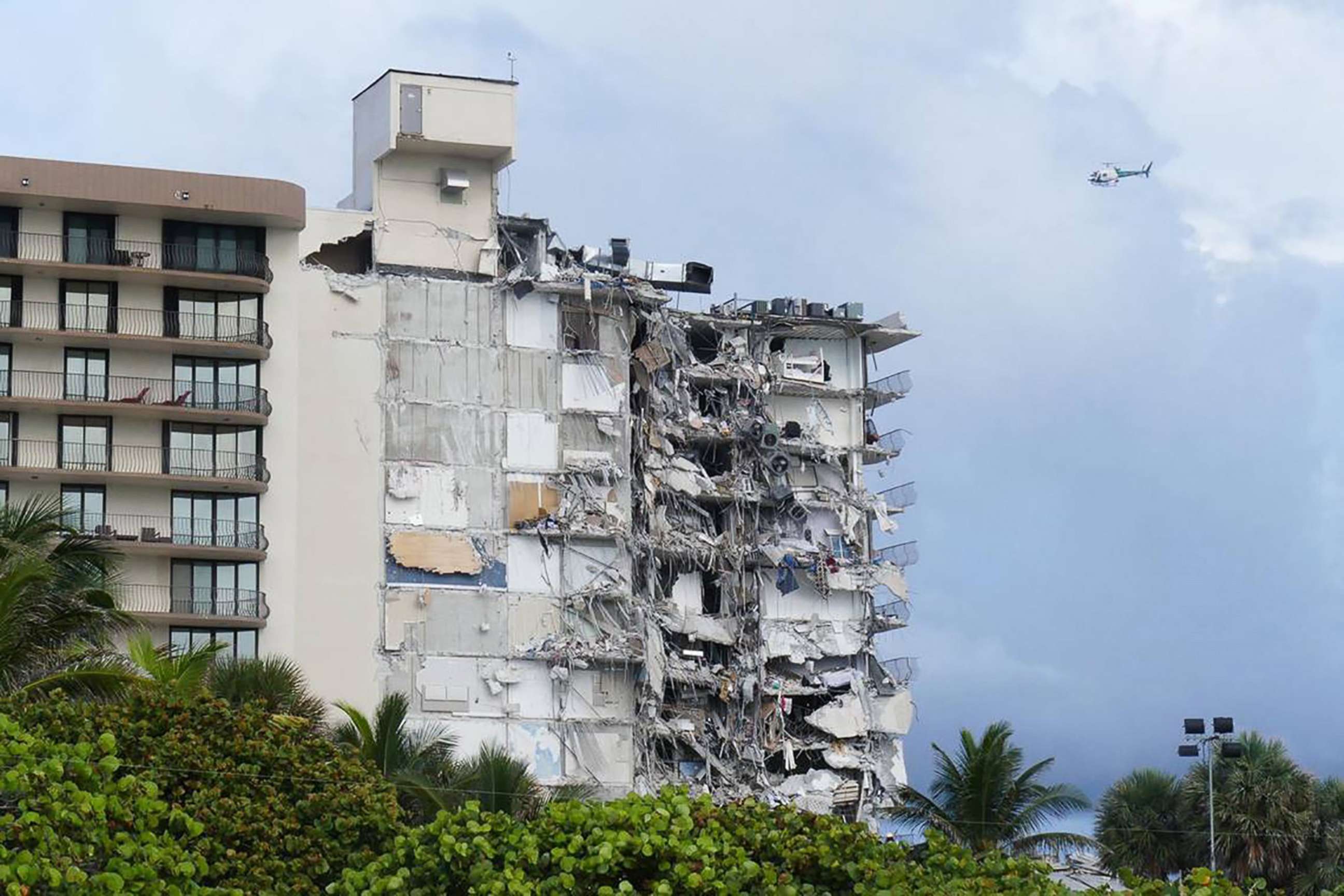 PHOTO: The partially collapsed facade of the Champlain Towers South condominium stands in Surfside, Fla. 