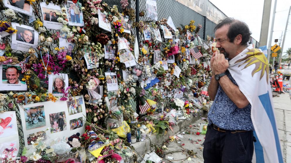 PHOTO: Bernardo Camou Fonte, 59, cries as he prays at the memorial wall in front of the site of the Champlain Towers South condo collapse in Surfside, Florida, July 6, 2021.