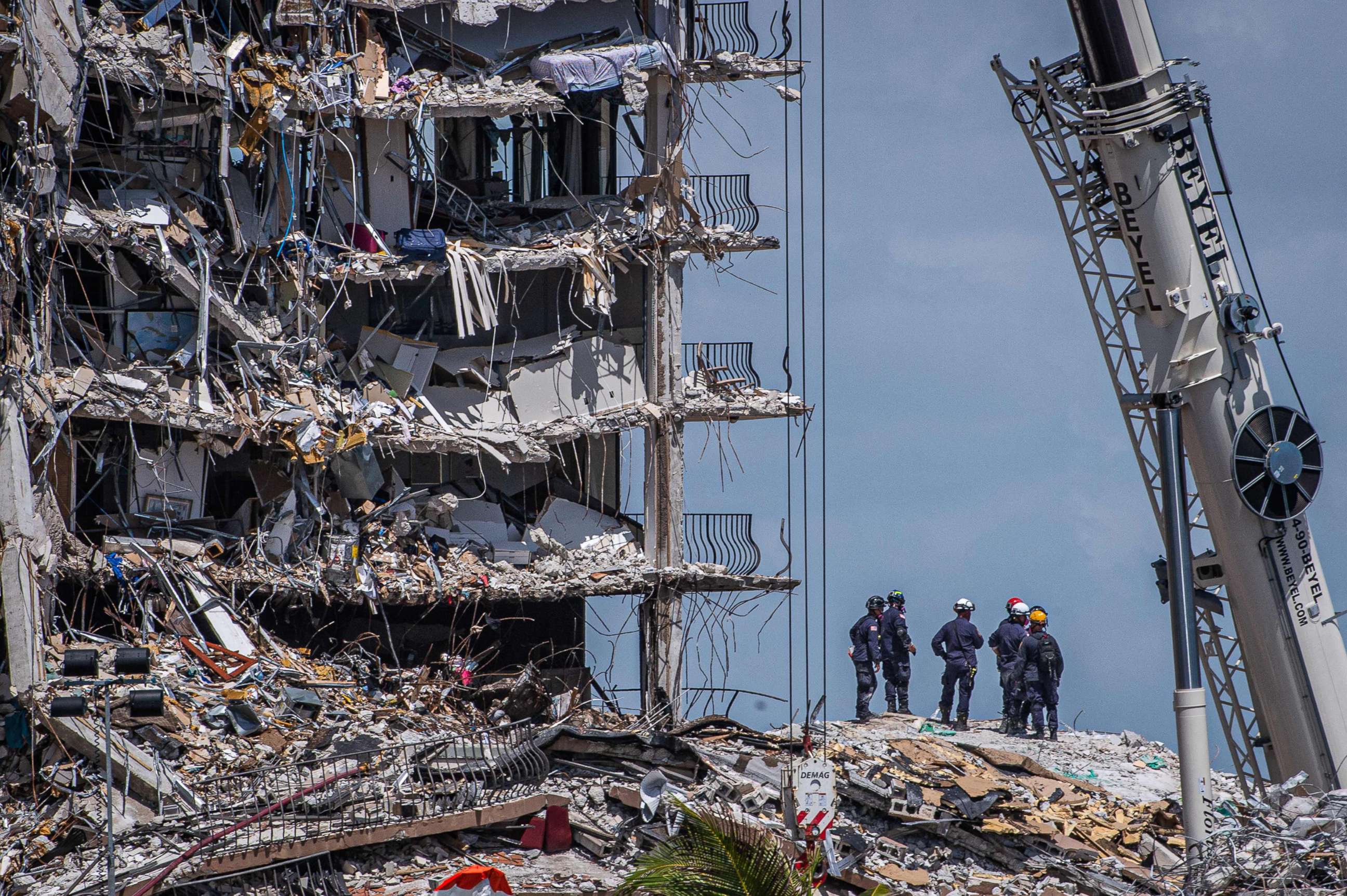 PHOTO: Members of the South Florida Urban Search and Rescue team look for survivors in the partially collapsed 12-story Champlain Towers South condo building, June 27, 2021, in Surfside, Fla., near Miami Beach.