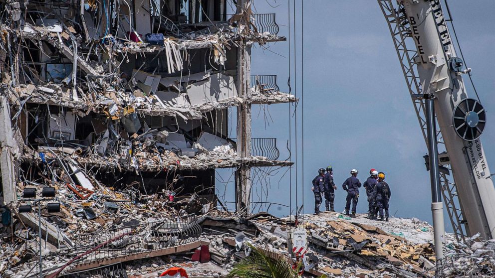 PHOTO: Members of the South Florida Urban Search and Rescue team look for survivors in the partially collapsed 12-story Champlain Towers South condo building, June 27, 2021, in Surfside, Fla., near Miami Beach.