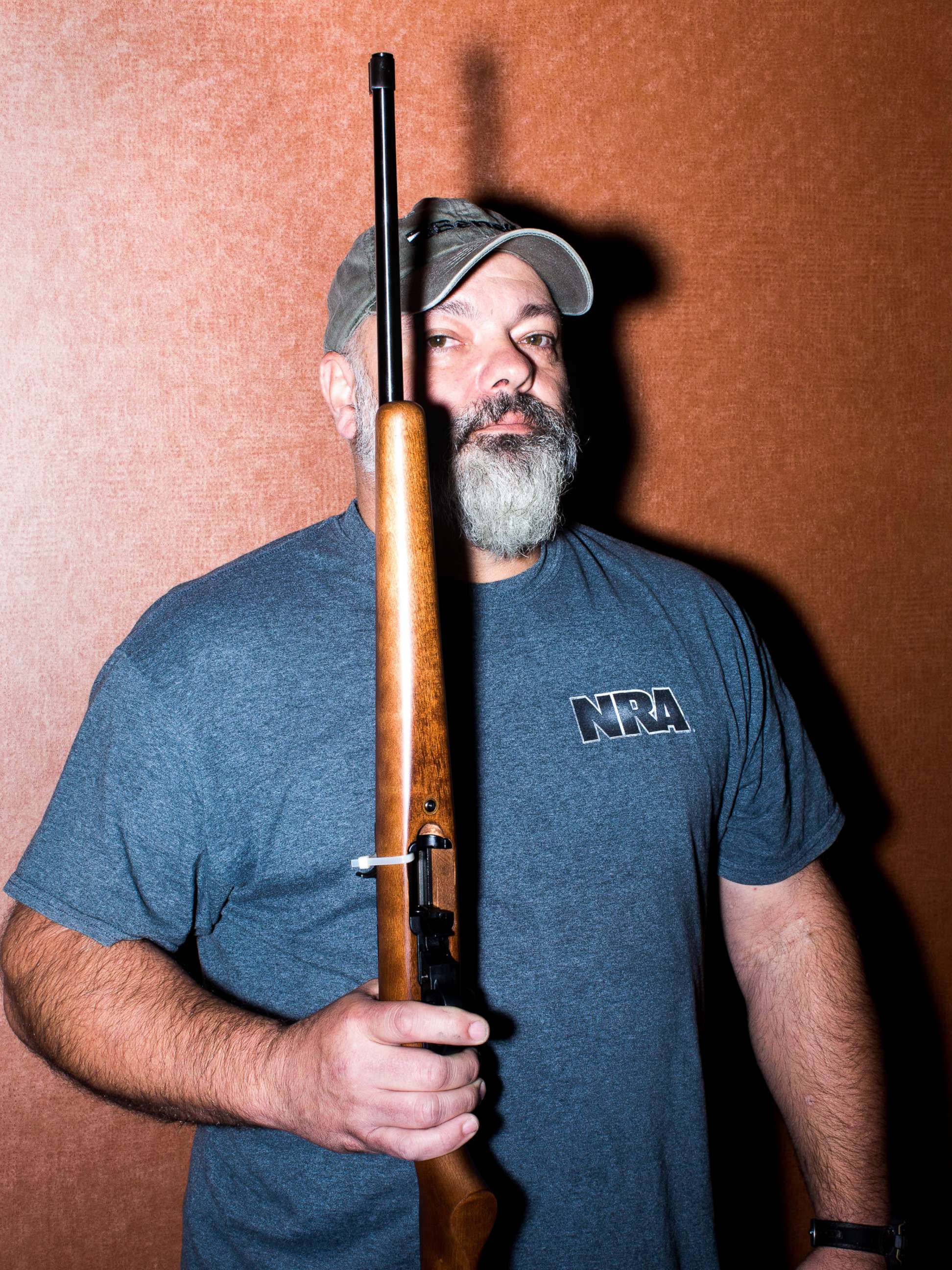 PHOTO: Chuck Cook  holds a gun as he poses.