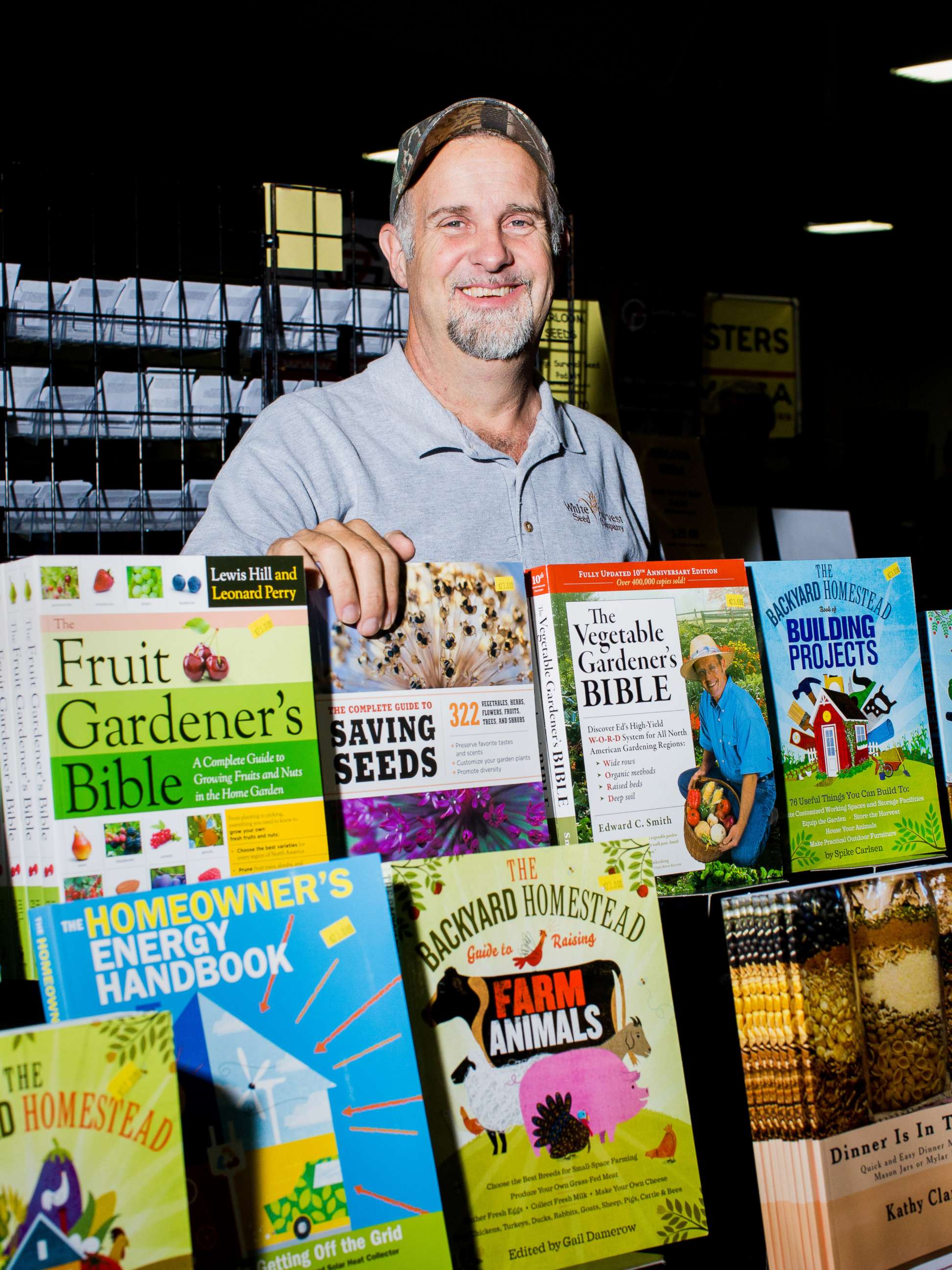 PHOTO: Mike Nocks stands behind a collection of books on display.
