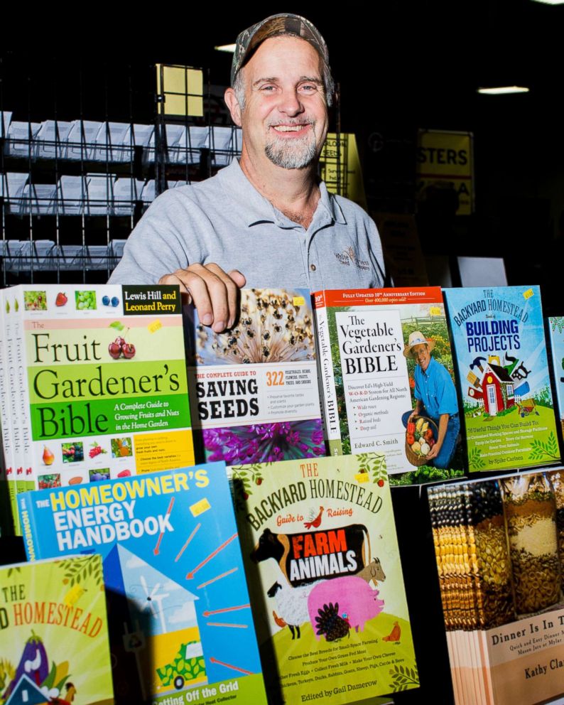 PHOTO: Mike Nocks stands behind a collection of books on display.