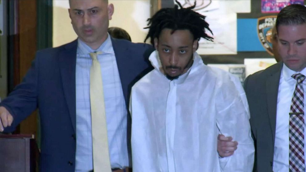 PHOTO: Jovan Young, 29, is walked by police detectives after his arrest, June 8, 2021, on charges related to the shooting death of 10-year-old Justin Wallace in Queen, New York.
