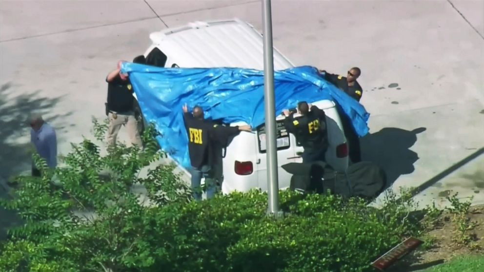 In this frame grab by WPLG-TV, FBI agents cover a plant in Plantation, Fla., Oct. 26, 2018, of a suspect in the mass bomb mailings. 