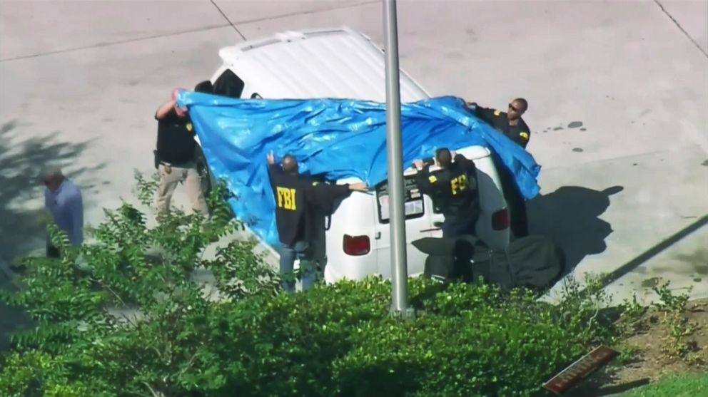 In this frame grab from video provided by WPLG-TV, FBI agents cover a van parked in Plantation, Fla., Oct. 26, 2018, of a suspect in the mass bomb mailings. 