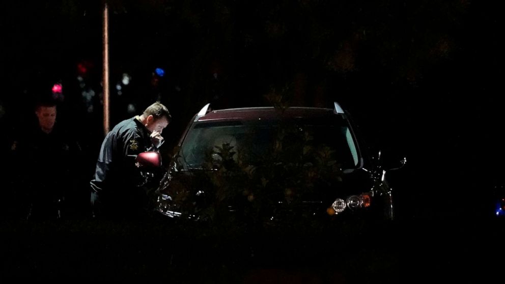 PHOTO: Law enforcement officials look into a vehicle parked in the area where a shooting suspect's vehicle was found Monday, Jan. 23, 2023, in Half Moon Bay, Calif.