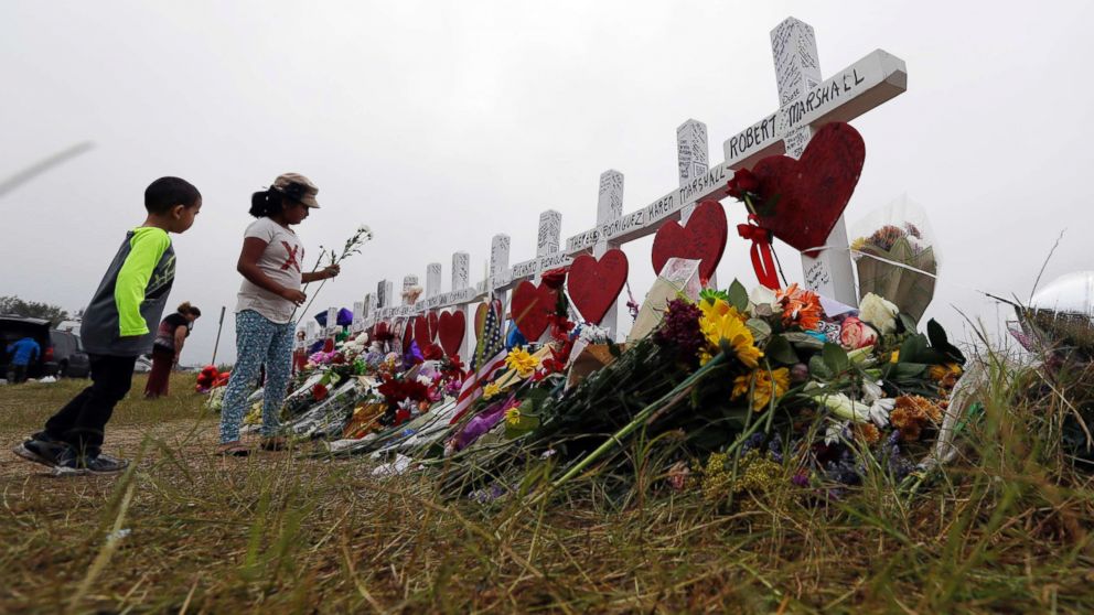 PHOTO: Alexander Osborn and Bella Araiza leave flowers at a makeshift memorial for the victims of the shooting at Sutherland Springs Baptist Church, Nov. 12, 2017, in Sutherland Springs, Texas. 