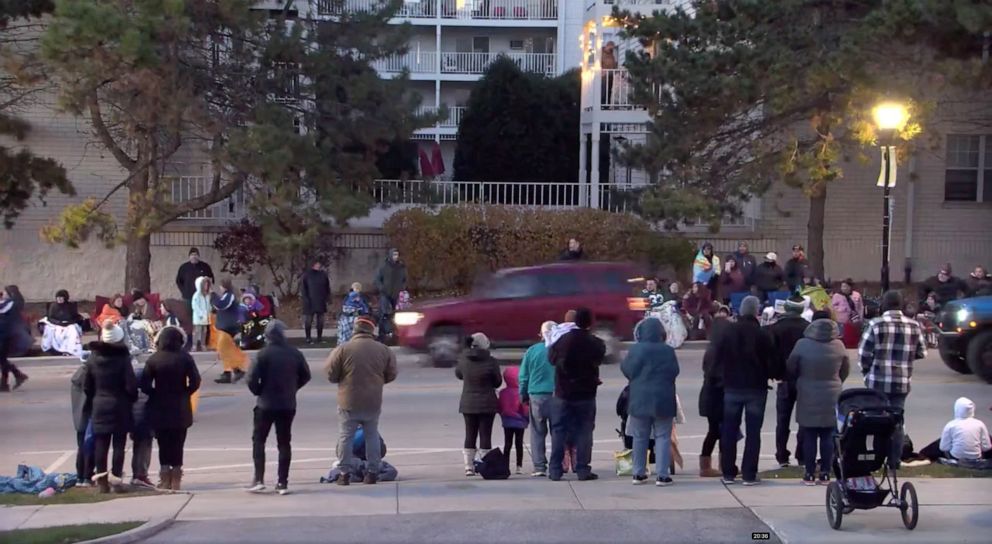 PHOTO: A red SUV speeds past attendees moments before plowing into a crowd at a Christmas parade in Waukesha, Wis., in an image from video, Nov.  21, 2021.