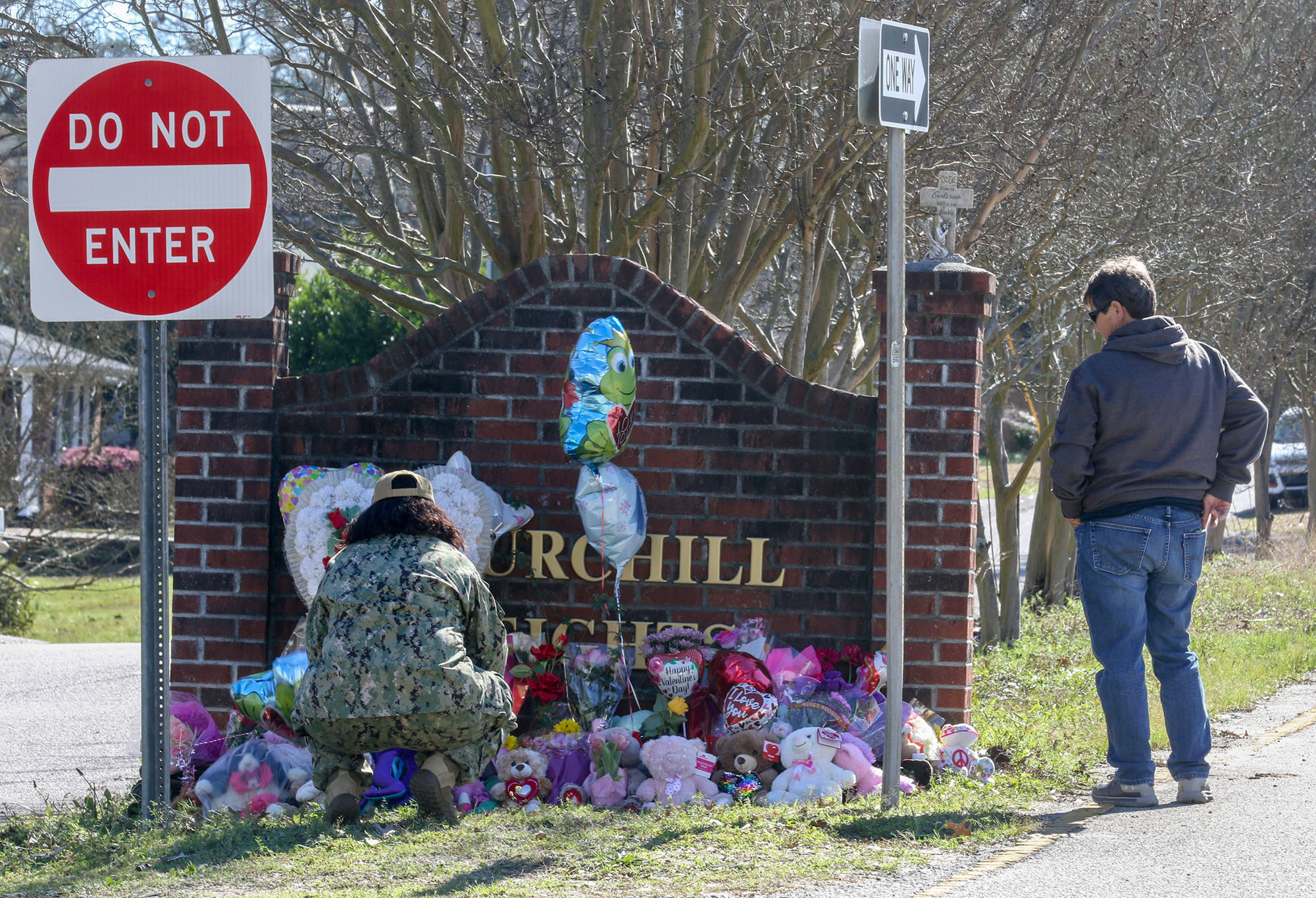 PHOTO: People look at the memorial in honor of slain 6-year-old Faye Swetlik at the entrance to Churchill Heights where she lived in Columbia, S.C., on Feb. 14, 2020.