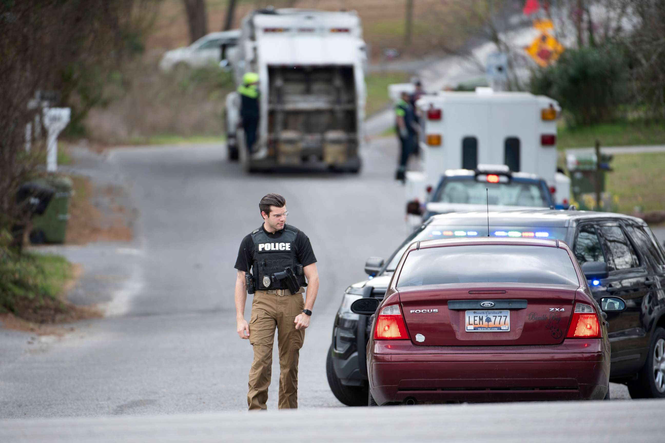 PHOTO: A Cayce police officer approaches a vehicle at a road block near an entrance to the Churchill Heights neighborhood, Feb. 13, 2020, in Cayce, S.C., where six year-old Faye Marie Swetlik recently went missing.