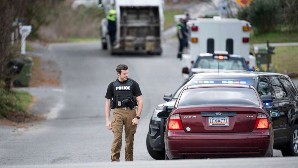 PHOTO: A Cayce police officer approaches a vehicle at a road block near an entrance to the Churchill Heights neighborhood, Feb. 13, 2020, in Cayce, S.C., where six year-old Faye Marie Swetlik recently went missing.