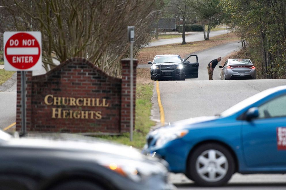 PHOTO: A law enforcement officer talks with a driver at a road block near an entrance to the Churchill Heights neighborhood, Feb.13, 2020, in Cayce, S.C.