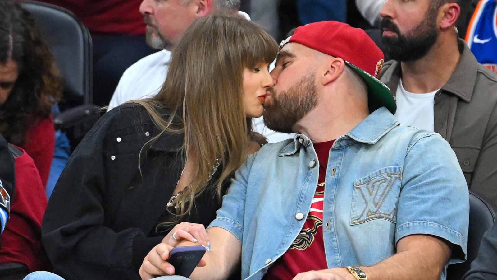 PHOTO: Taylor Swift and Travis Kelce kiss during Game Three between the New York Knicks and the Cleveland Cavaliers in the NBA Eastern Conference Finals, May 23, 2026 in Cleveland.
