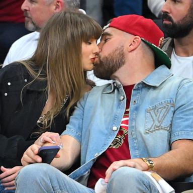 PHOTO: Taylor Swift and Travis Kelce kiss during Game Three between the New York Knicks and the Cleveland Cavaliers in the NBA Eastern Conference Finals, May 23, 2026 in Cleveland.