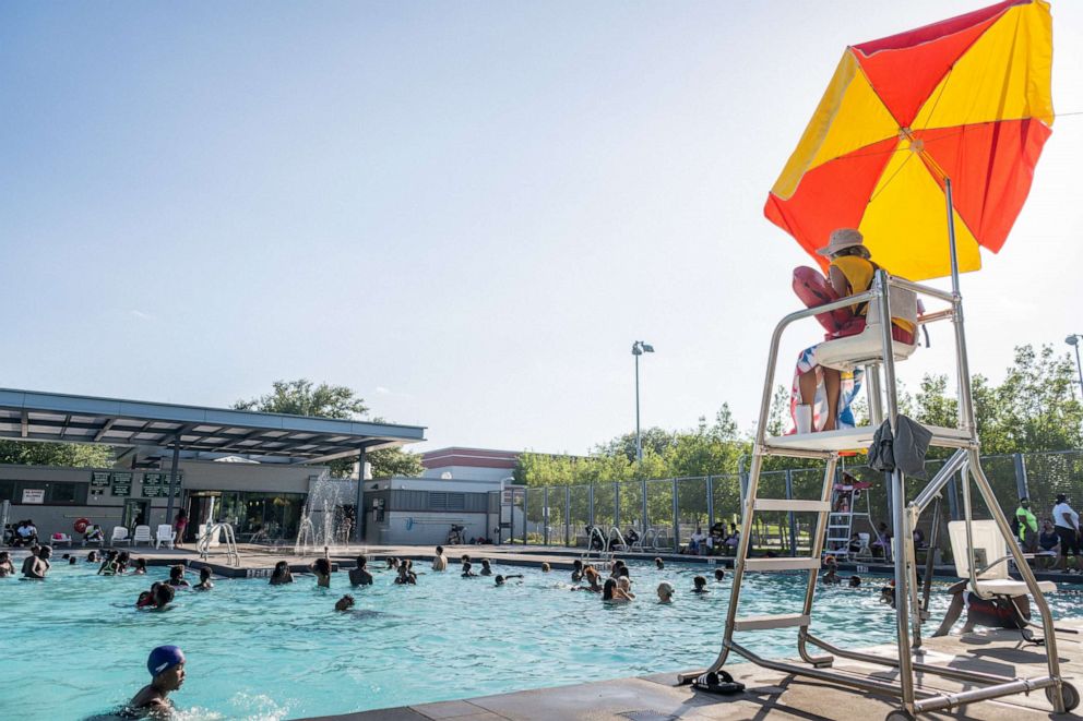 PHOTO: A lifeguard watches over people swimming at the Emancipation Swimming Pool in Houston, Texas, July 19, 2022.