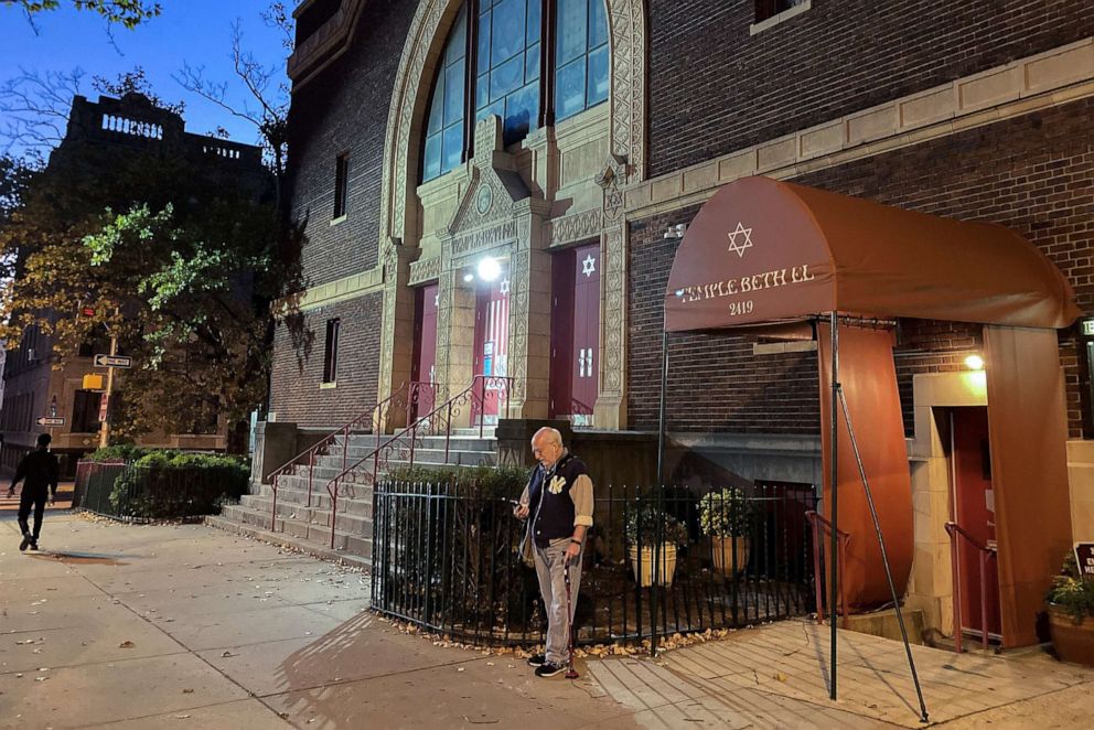 PHOTO: A man stands outside the Temple Beth El synagogue, November 3, 2022, in Jersey City, NJ 