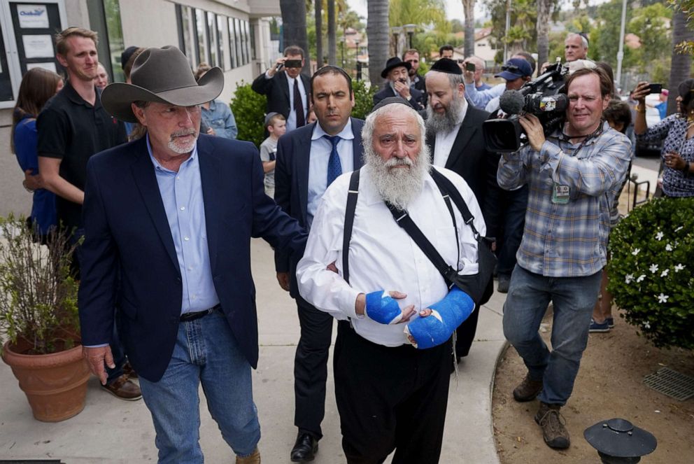 PHOTO: Executive Director Rabbi Ysrael Goldstein, who was shot in the hands, walks towards a press conference with Poway Mayor Steve Vaus outside of the Chabad of Poway Synagogue on April 28, 2019 in Poway, Calif.