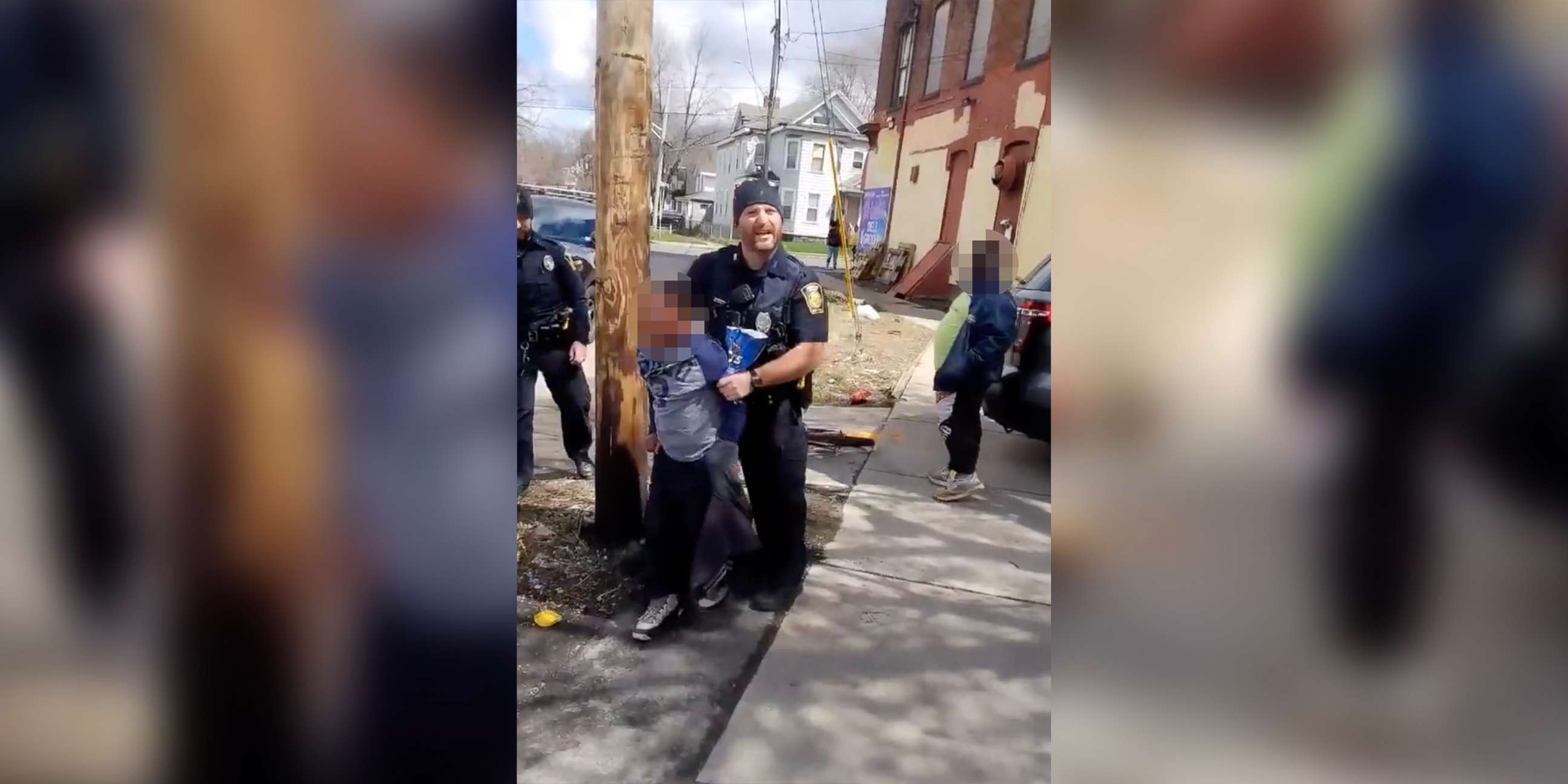 PHOTO: Syracuse police officers escort an 8yr old boy to a squad car, April 17, 2022.