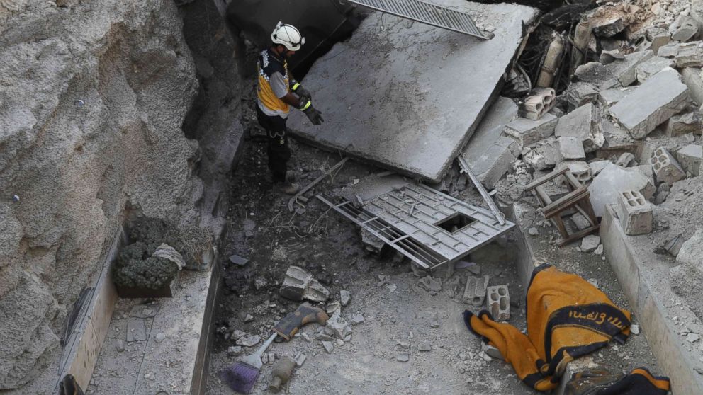 A member of the Syrian Civil Defence, also known as the "White Helmets", walks through the wreckage of their center which was destroyed by government forces' bombardment in the town of al-Tamana on the southern edges of the rebel-held Idlib province, Sept. 6, 2018.