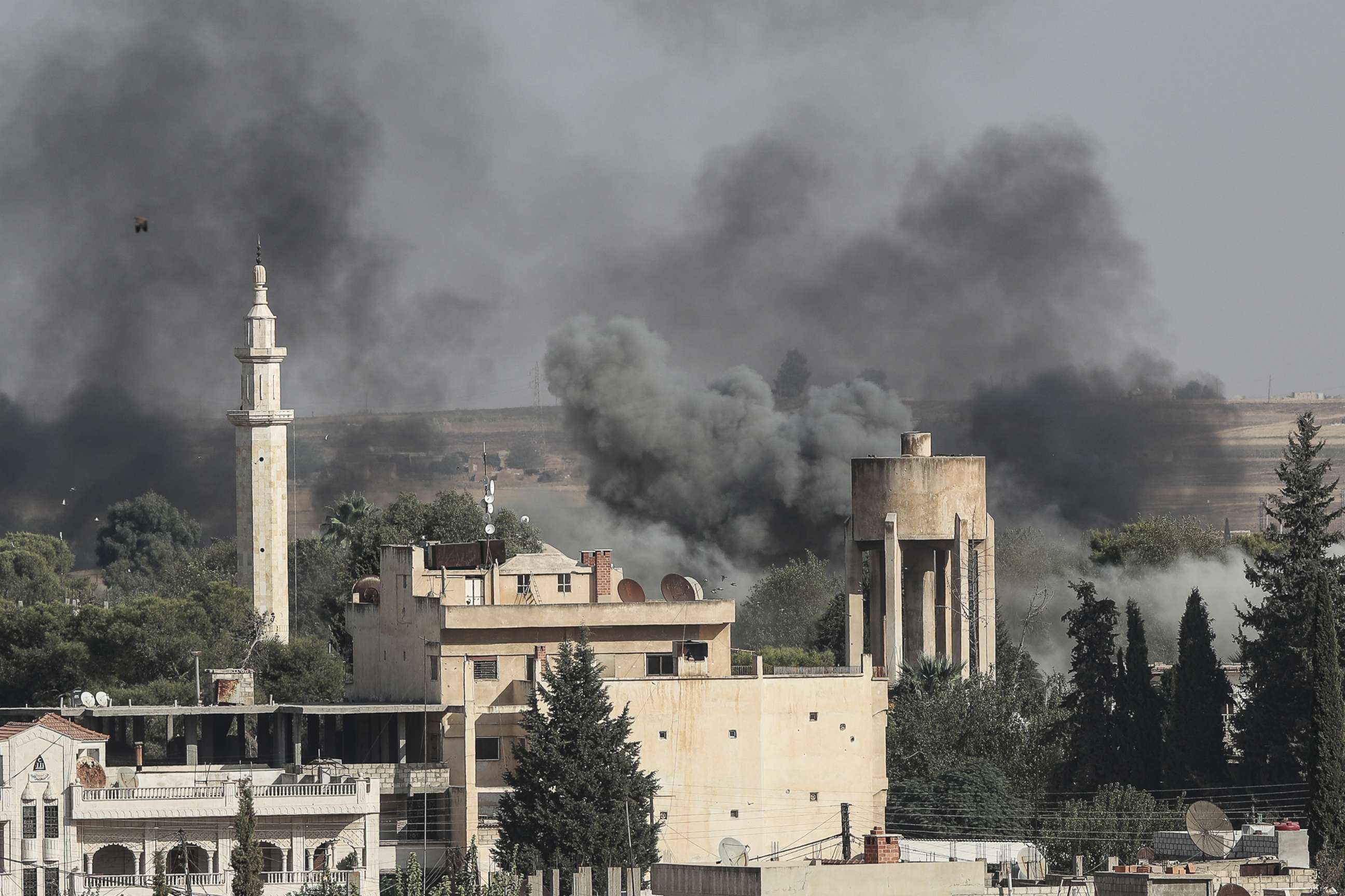 PHOTO: Smoke rises over the Syrian town of Ras al-Ain, as seen from the Turkish border town on October 09, 2019, in Ceylanpinar, Turkey.