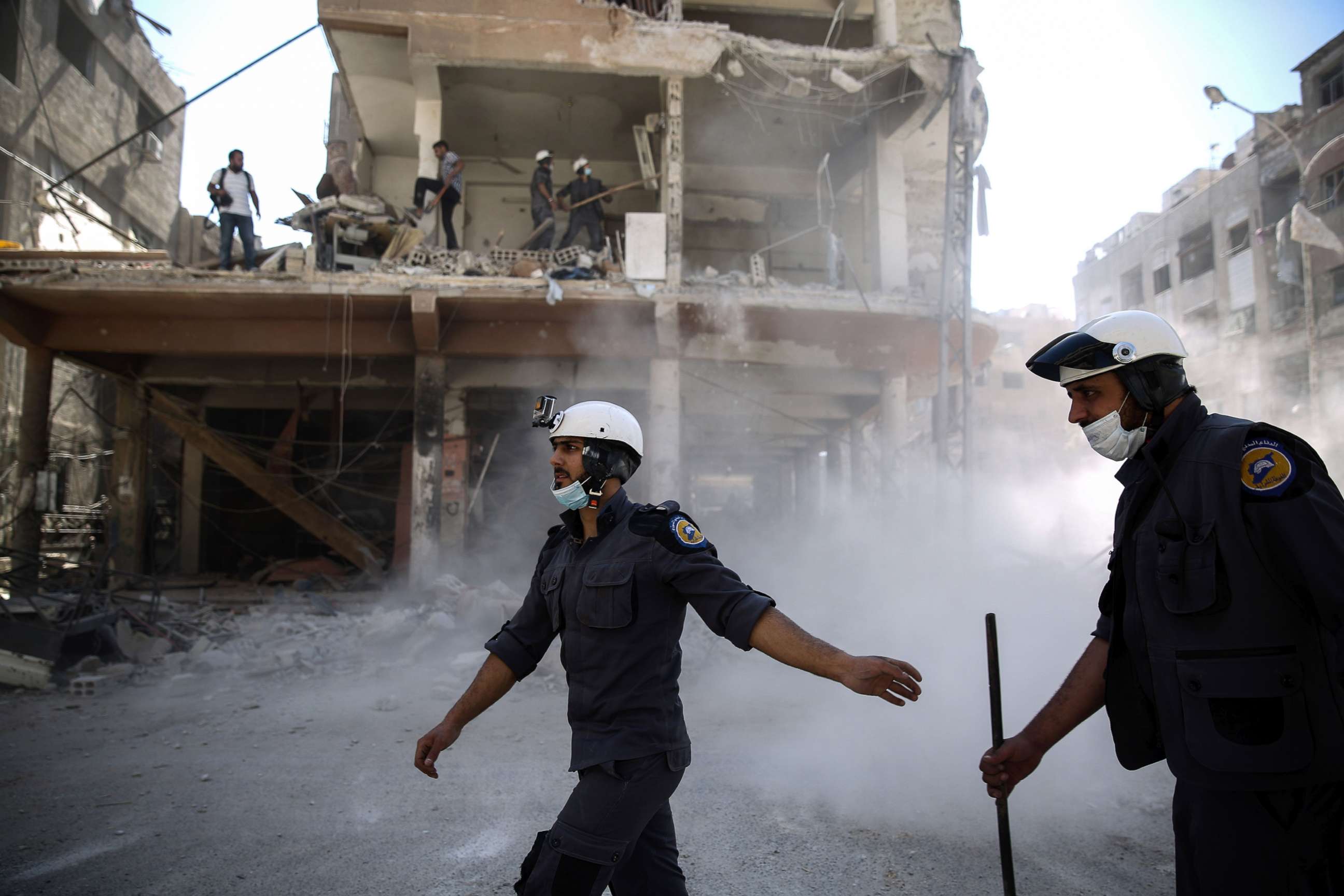 PHOTO: Syrian civil defense volunteers, known as the White Helmets, work around destroyed buildings following reported air strikes on the rebel-held town of Douma, on the eastern outskirts of the capital Damascus, Oct. 5, 2016.