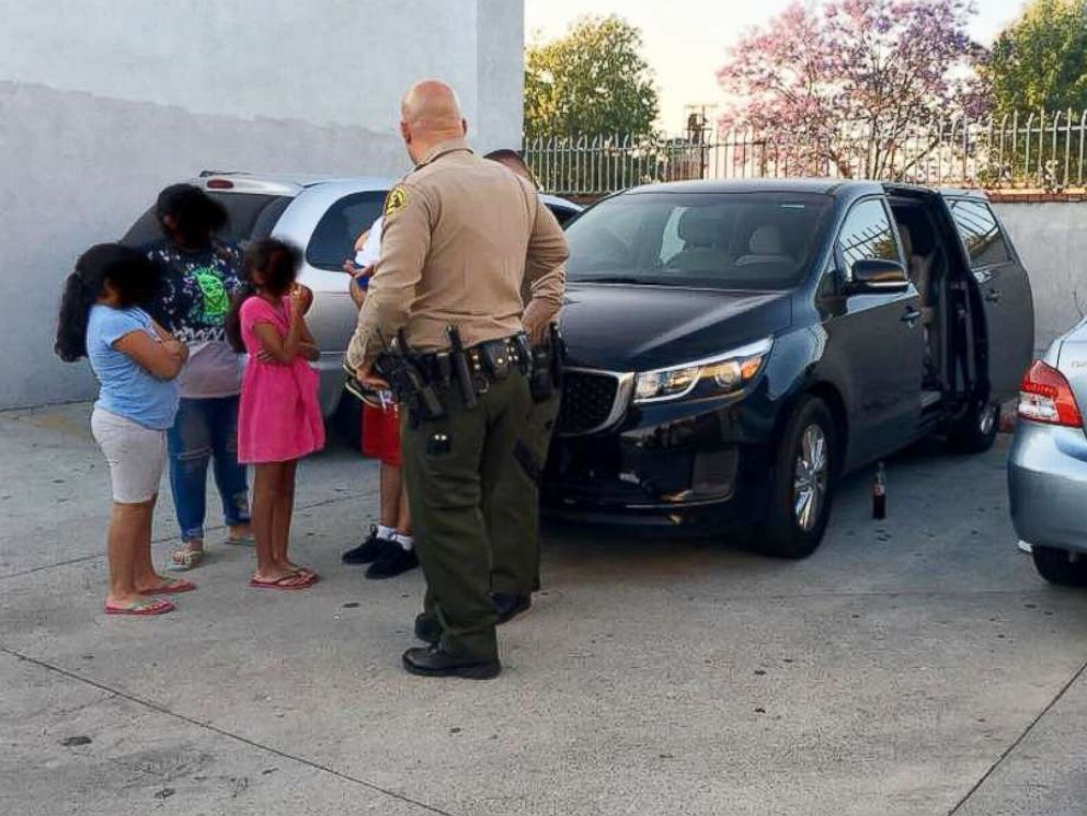 PHOTO: A family of six that was accosted by an armed man while eating a meal in a vehicle parked in City of Industry, Calif., June 10, 2018 is pictured speaking to law enforcement.