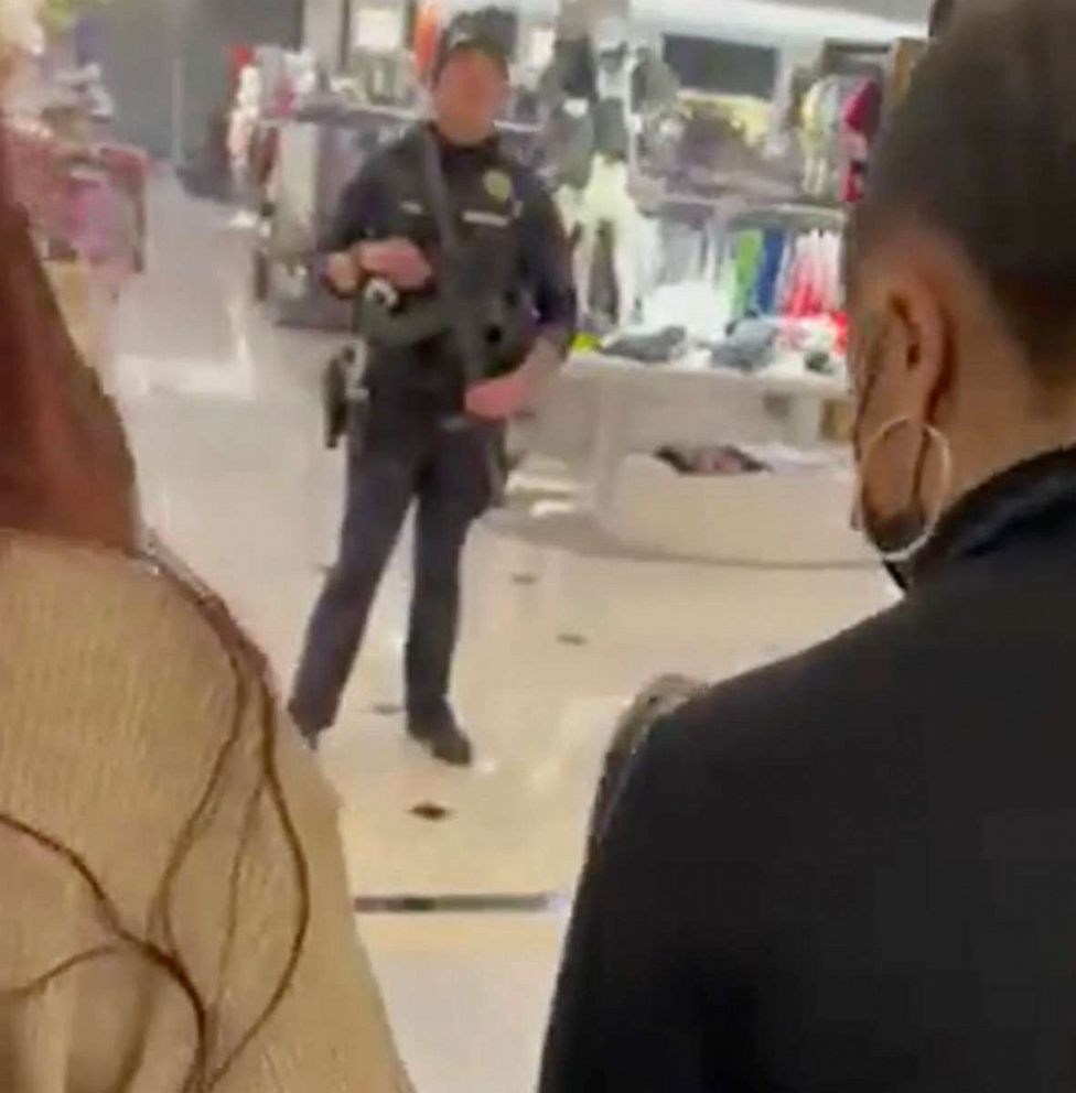 PHOTO: Shoppers pass by police after as the exit the Tacoma Mall after a shooting on Black Friday, Nov. 26, 2021, in Tacoma, Wash.