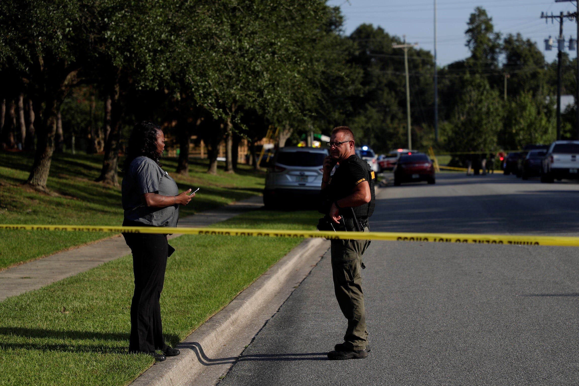 PHOTO: A woman talks to an officer on scene after a relative was stabbed before a job interview at Dyke Industries on Sept. 11, 2019, in Tallahassee, Fla.
