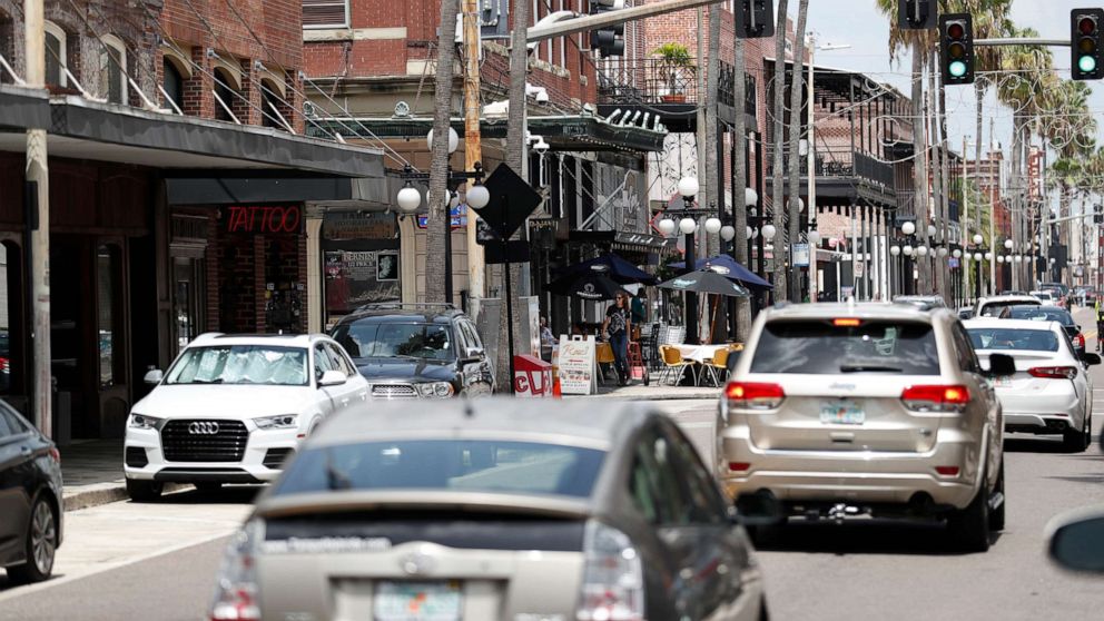PHOTO: In this June 26, 2020, file photo, cars are seen driving on 7th Avenue in the Ybor City neighborhood of Tampa, Fla.