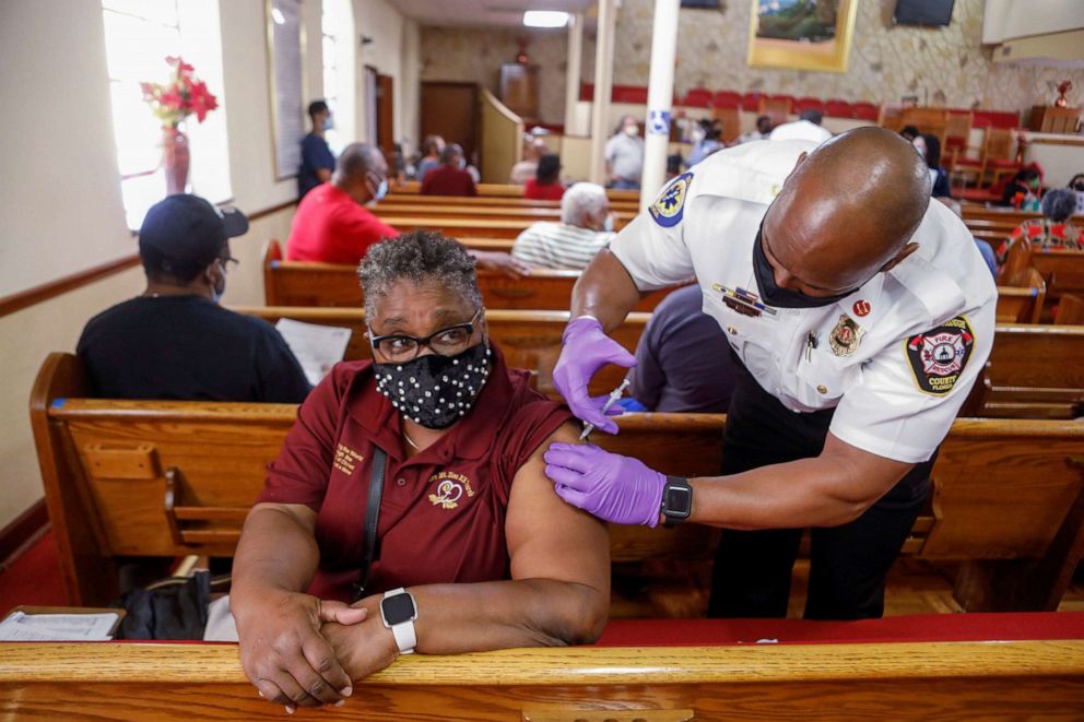 PHOTO: A woman receives the Pfizer-BioNTech COVID-19 vaccine from a Hillsborough County Fire Rescue paramedic at the historic Greater Bethel Missionary Baptist Church in Tampa, Fla., Feb. 14, 2021.