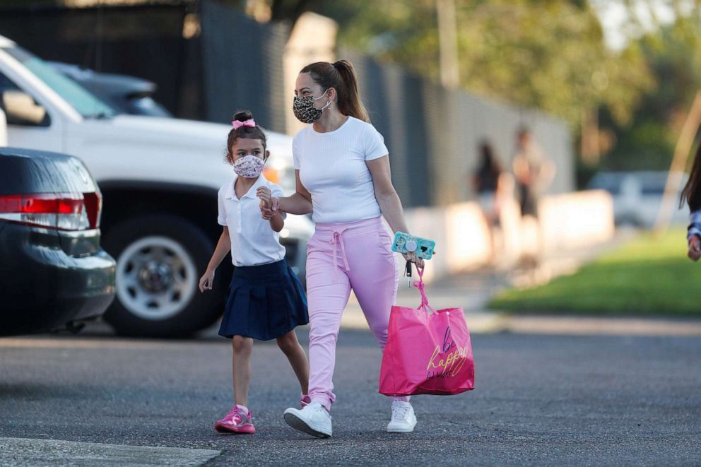 PHOTO: A mother walks her daughter on the first day of school at West Tampa Elementary School in Tampa, Fla., Aug. 10, 2021.
