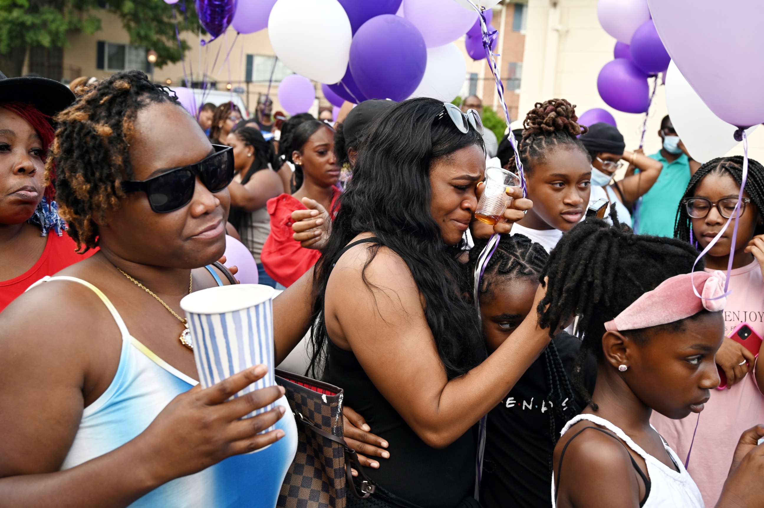 PHOTO: Tyrina Anderson, left, and dozens of friends, family and neighbors gather to mourn the loss of Taya Ashton, a 20-year-old transgender woman who was shot and killed at her apartment in Maryland, in Hillcrest Heights, Md., July 21, 2021. 