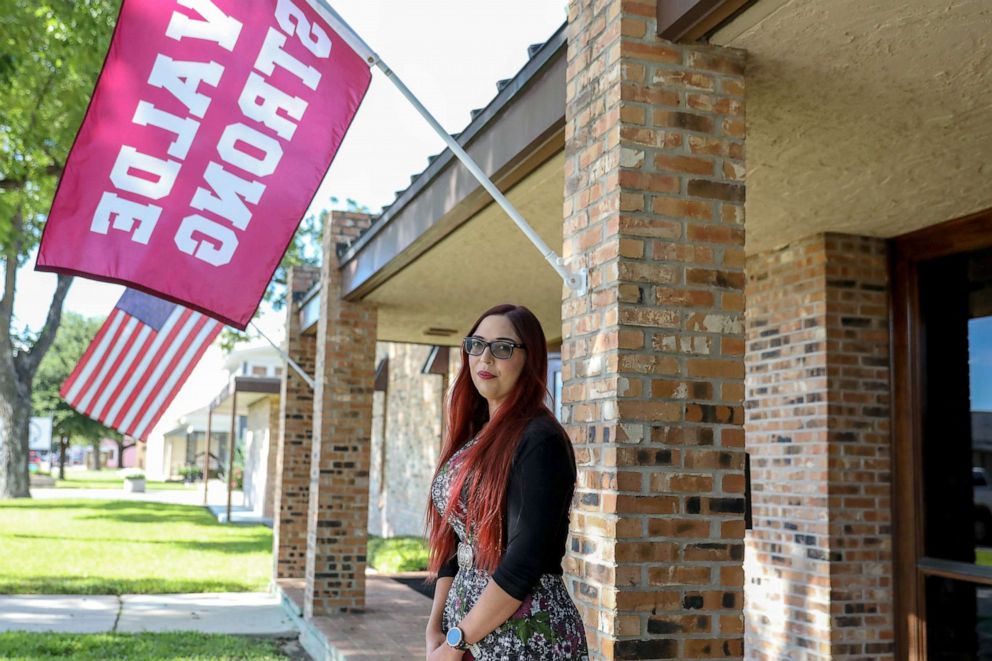 PHOTO: Taylor Michelle Massey, manager of Rushing-Estes-Knowles Mortuary, Inc. poses for a portait outside of the funeral home which features a "Uvalde Strong" flag on Aug. 18, 2022, in Uvalde, TX.