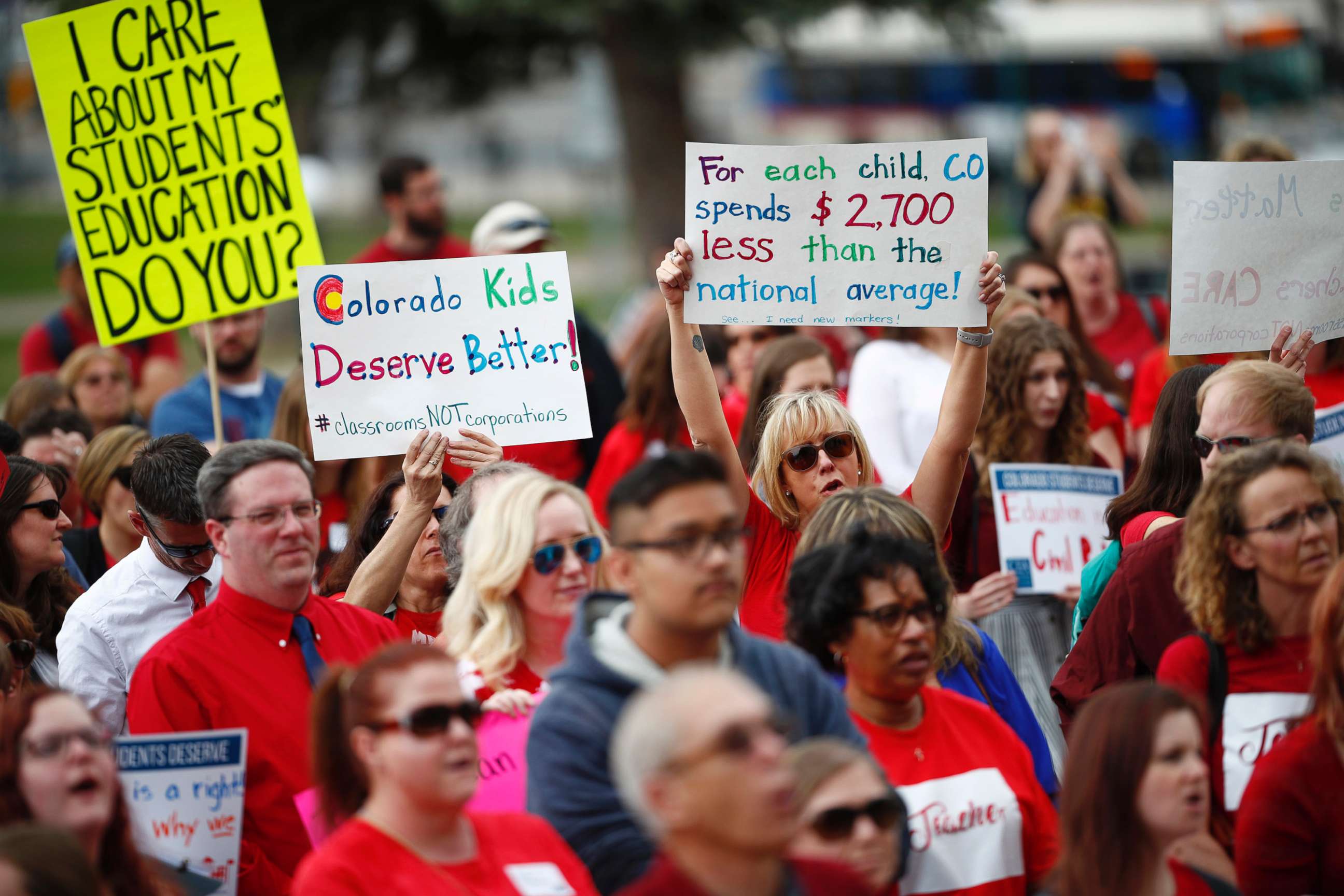 PHOTO: Teachers hold placards during a rally outside the state Capitol, April 16, 2018, in Denver. 