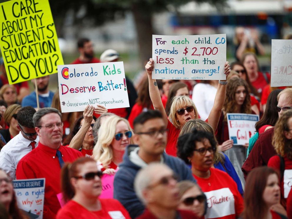 PHOTO: Teachers hold placards during a rally outside the state Capitol, April 16, 2018, in Denver.