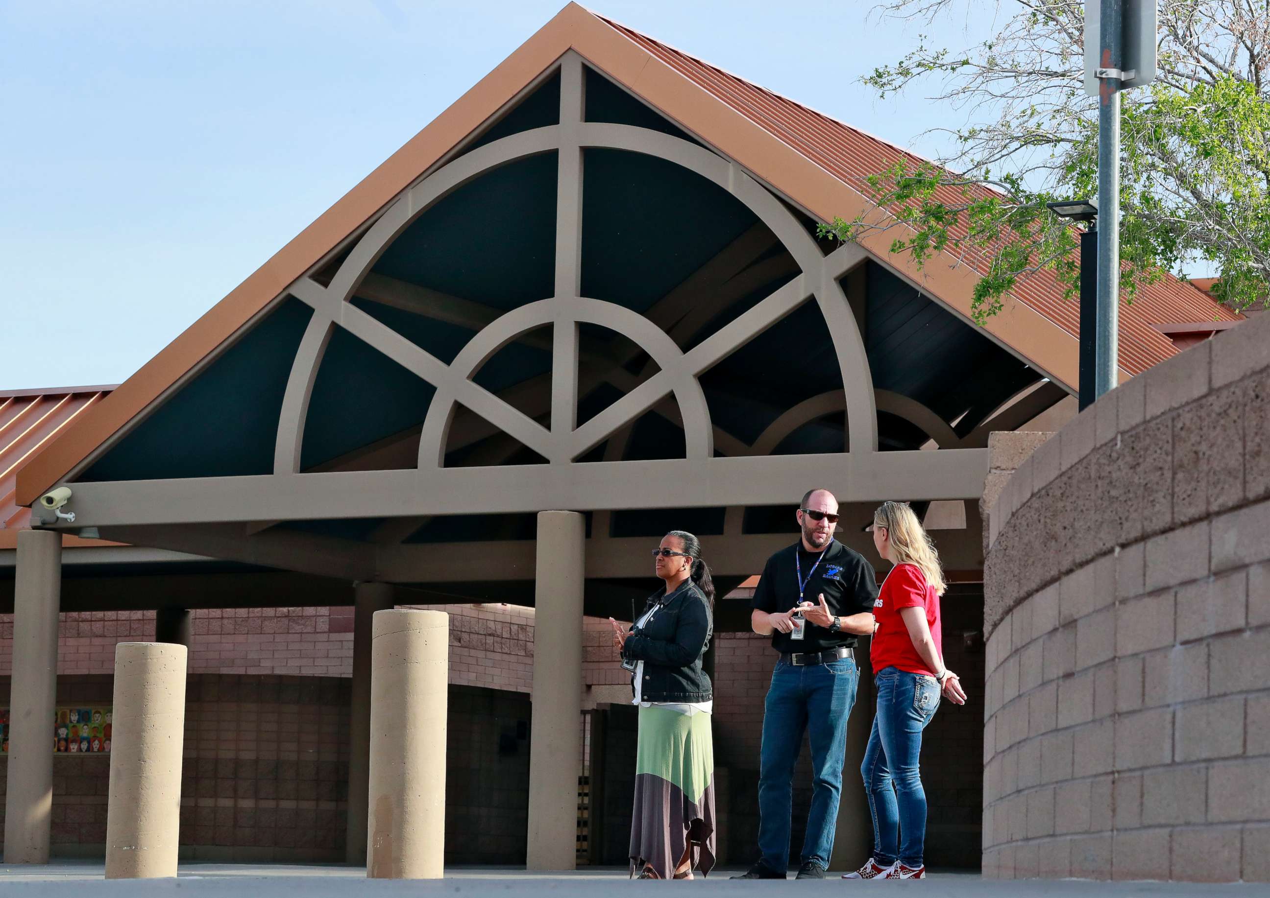 PHOTO: Principal Brian Gibson, center, and vice principal Melissa Taylor, left, stand at the entrance of Kyrene De Las Lomas Elementary School to turn students away during a teacher walkout, April 26, 2018, in Phoenix.