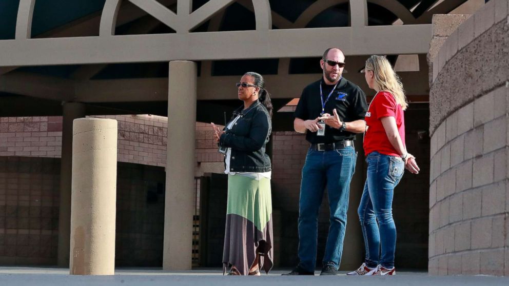 PHOTO: Principal Brian Gibson, center, and vice principal Melissa Taylor, left, stand at the entrance of Kyrene De Las Lomas Elementary School to turn students away during a teacher walkout, April 26, 2018, in Phoenix.
