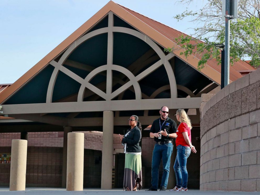 PHOTO: Principal Brian Gibson, center, and vice principal Melissa Taylor, left, stand at the entrance of Kyrene De Las Lomas Elementary School to turn students away during a teacher walkout, April 26, 2018, in Phoenix.