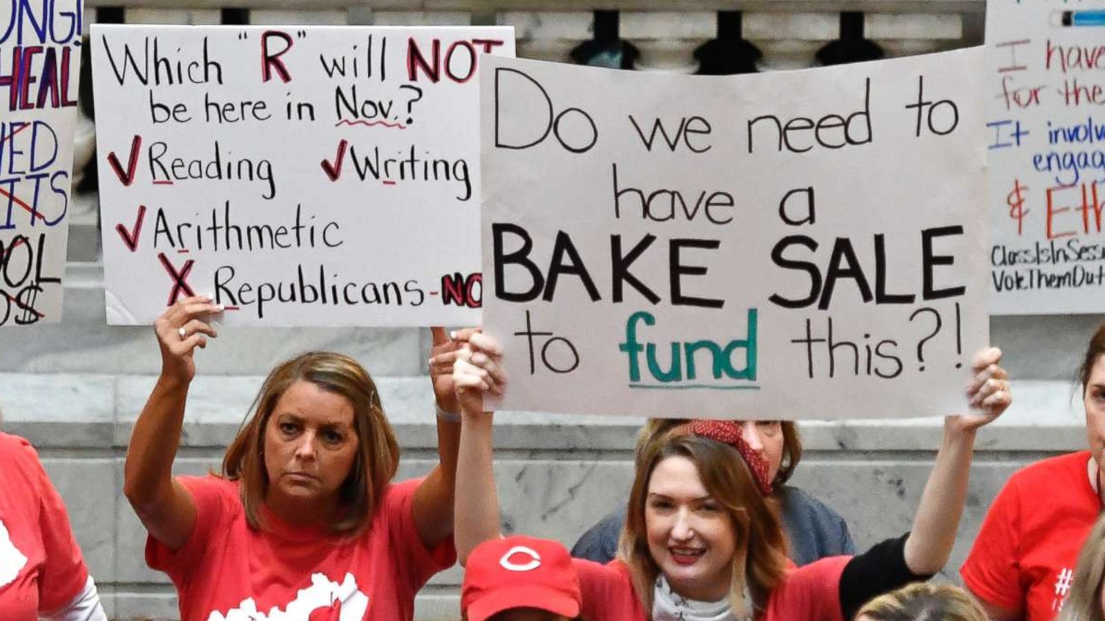 PHOTO: Teachers from across Kentucky hold up signs as they fill the state Capitol to rally for increased funding and to protest last minute changes to their state funded pension system, April 2, 2018, in Frankfort, Ky.