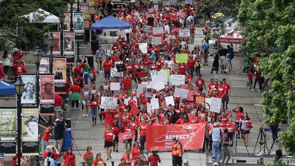 PHOTO: Participants make their way towards the Legislative Building during a teachers rally at the General Assembly in Raleigh, N.C., on May 16, 2018.