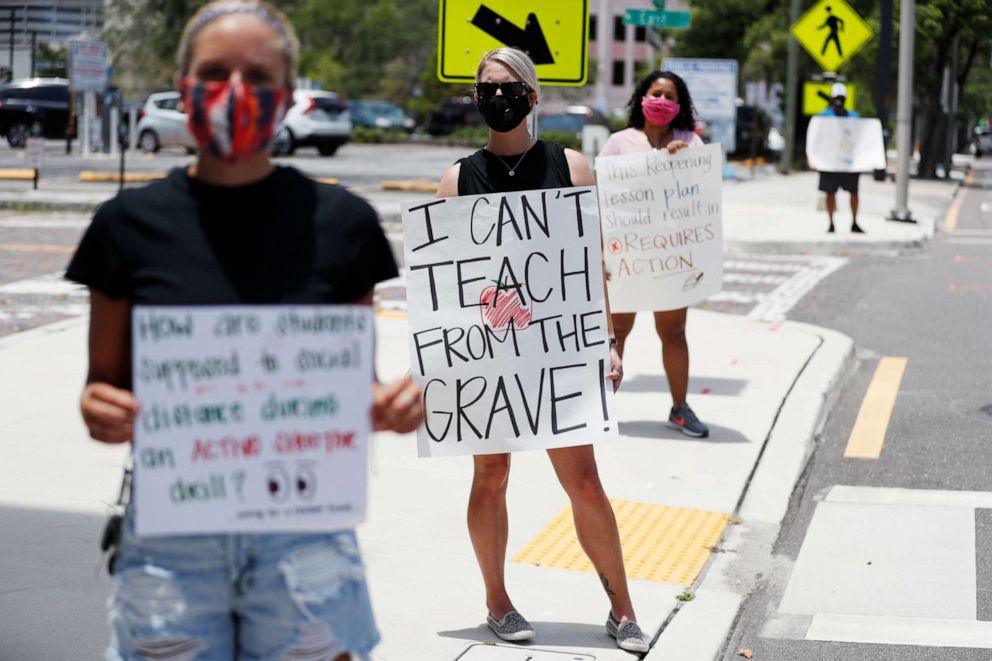 PHOTO: Brittany Myers, center, protests in front of the Hillsborough County Schools District Office in Tampa, Fla., July 16, 2020. Teachers and administrators from school district rallied against the reopening of schools due concerns over the pandemic. 