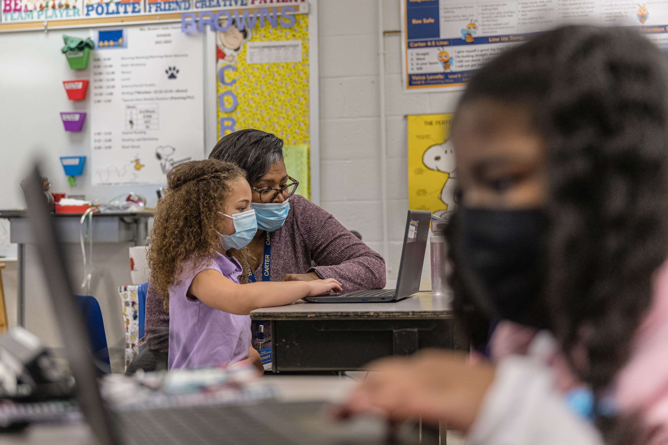 PHOTO: Nicole Brown, a second grade teacher, sits at a laptop computer with one of her students during a lesson in Louisville, Ky., Jan. 24, 2022.