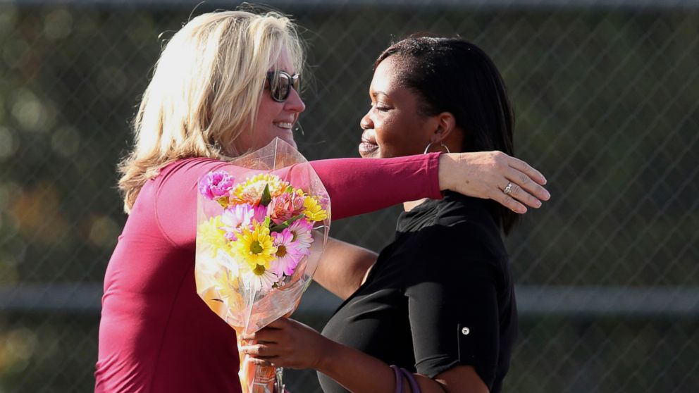 PHOTO: Marjory Stoneman Douglas High School assistant principal Denise Reed hugs a school employee as she returns to the school, Feb. 23, 2018. 