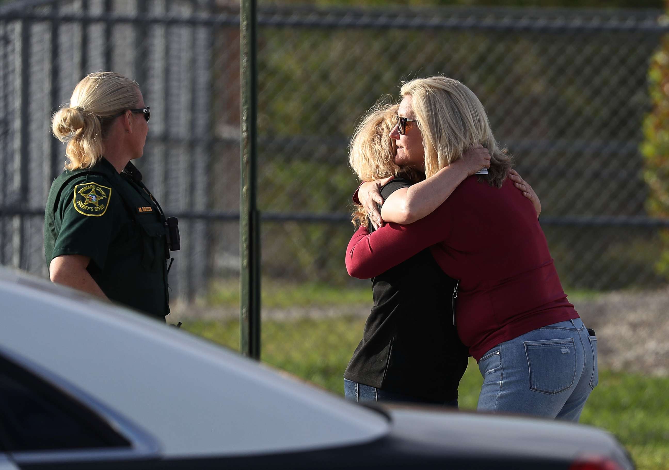 PHOTO: Assistant Principle Denise Reed (R) hugs a school employee as teachers and staff are allowed to return to the school for the first time since the mass shooting on campus on Feb. 23, 2018 in Parkland, Florida. 