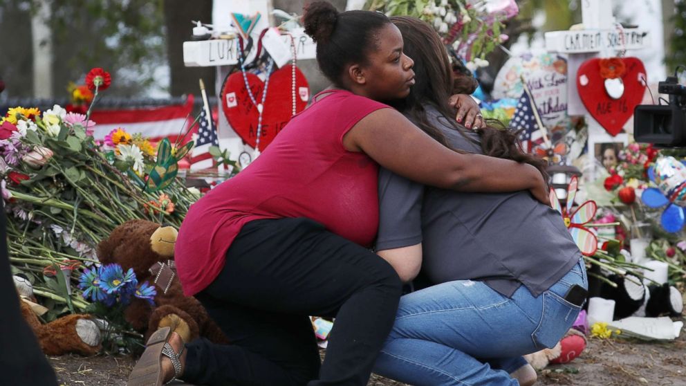 Elizabeth Smith (L) and Lindsey Riha both teachers at Marjory Stoneman Douglas High School hug each other as staff return to the school for the first time since the mass shooting on campus, Feb. 23, 2018 in Parkland, Florida. 